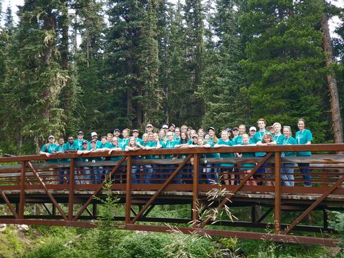 A group of youth standing on a bridge for Montana Models camp. 